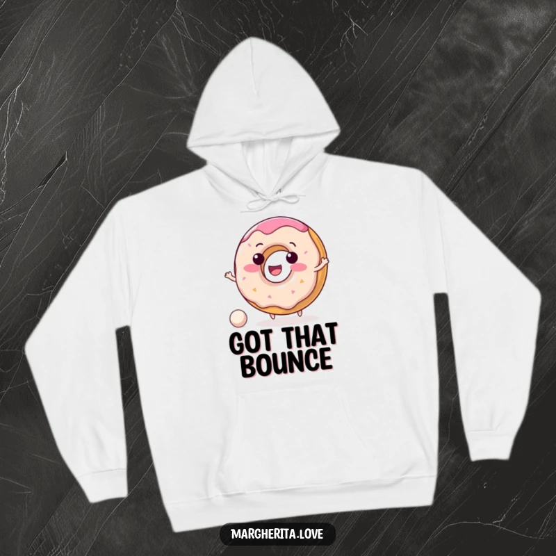 Funny donut hoodie with a delighted donut character happily bouncing a small ball, radiating warmth and happiness.