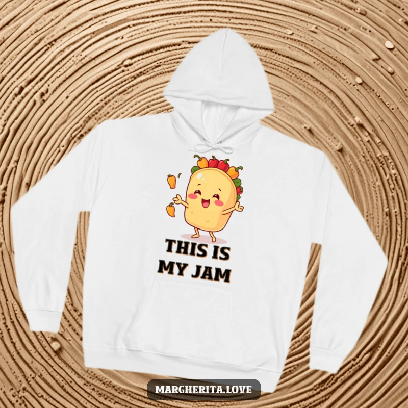 Funny hoodie depicting a cheerful taco character in mid-air, skillfully juggling tiny bell peppers with impressive gusto and joy.